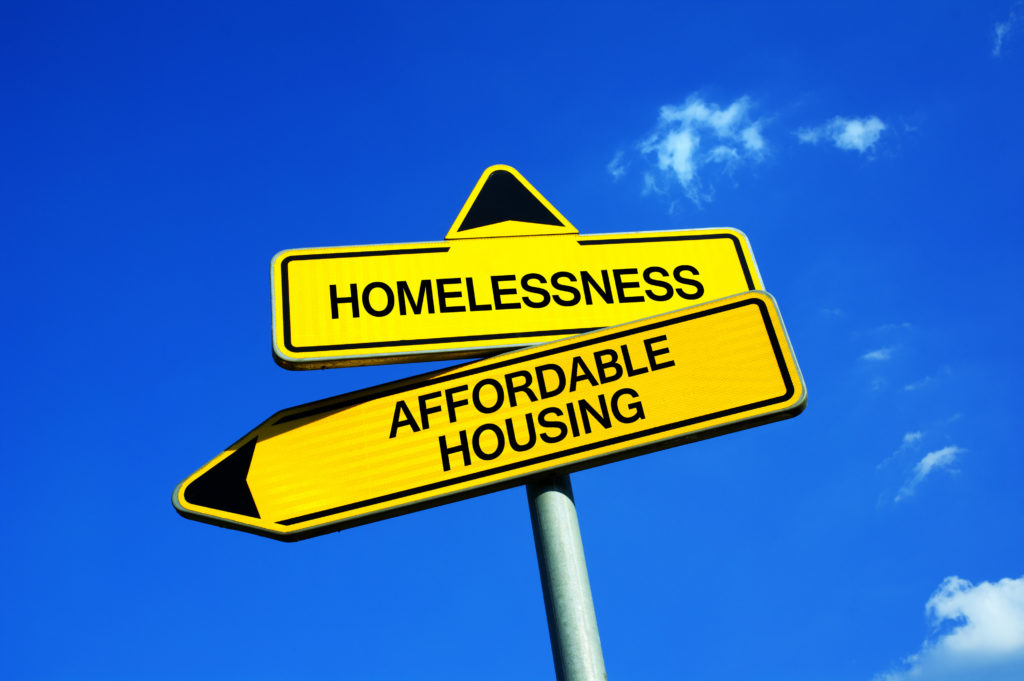 Homelessness vs Affordable Housing - Traffic sign with two options - Appeal to provide social housing for poor people. Prevention against homelessness